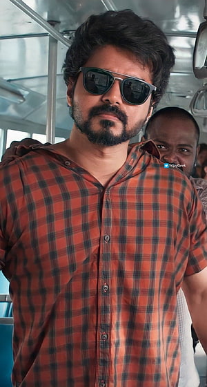 Vijay Sethupathi in red plaid shirt and sunglasses on a bus HD phone wallpaper