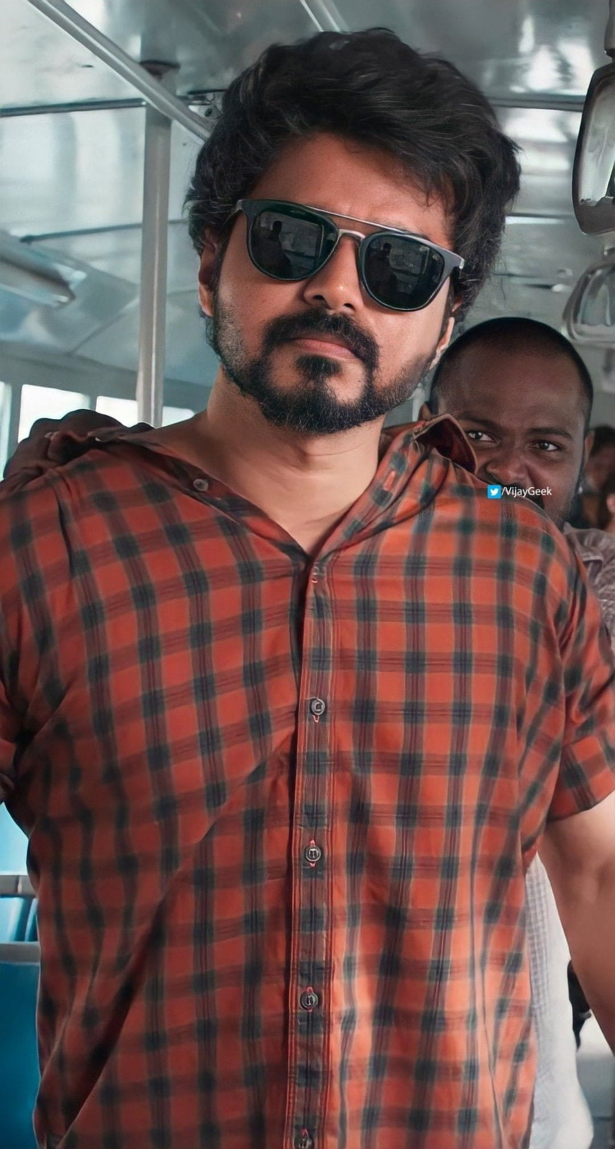 Vijay Sethupathi in red plaid shirt and sunglasses on a bus HD phone wallpaper