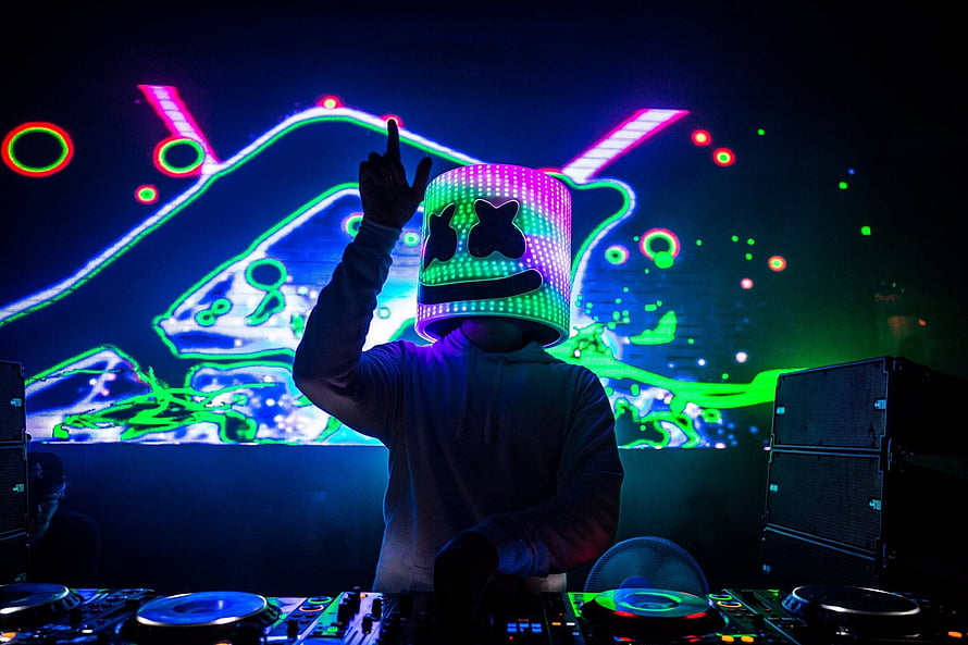 Marshmello performing live on stage with neon LED mask and colorful concert lighting HD wallpaper
