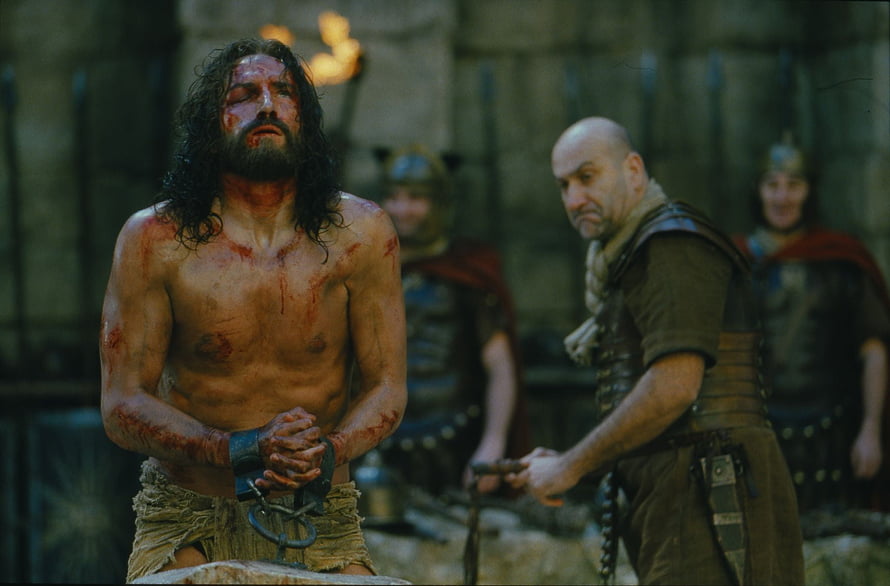 The Passion of the Christ Film Still Depicting a Bloodied Prisoner in Roman Custody HD wallpaper