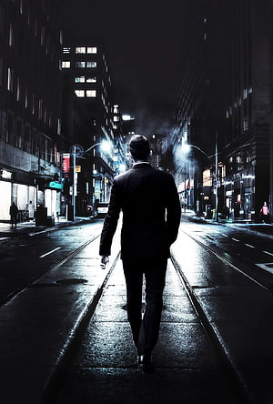 Silhouette of a man in a suit walking down a wet city street at night HD phone wallpaper