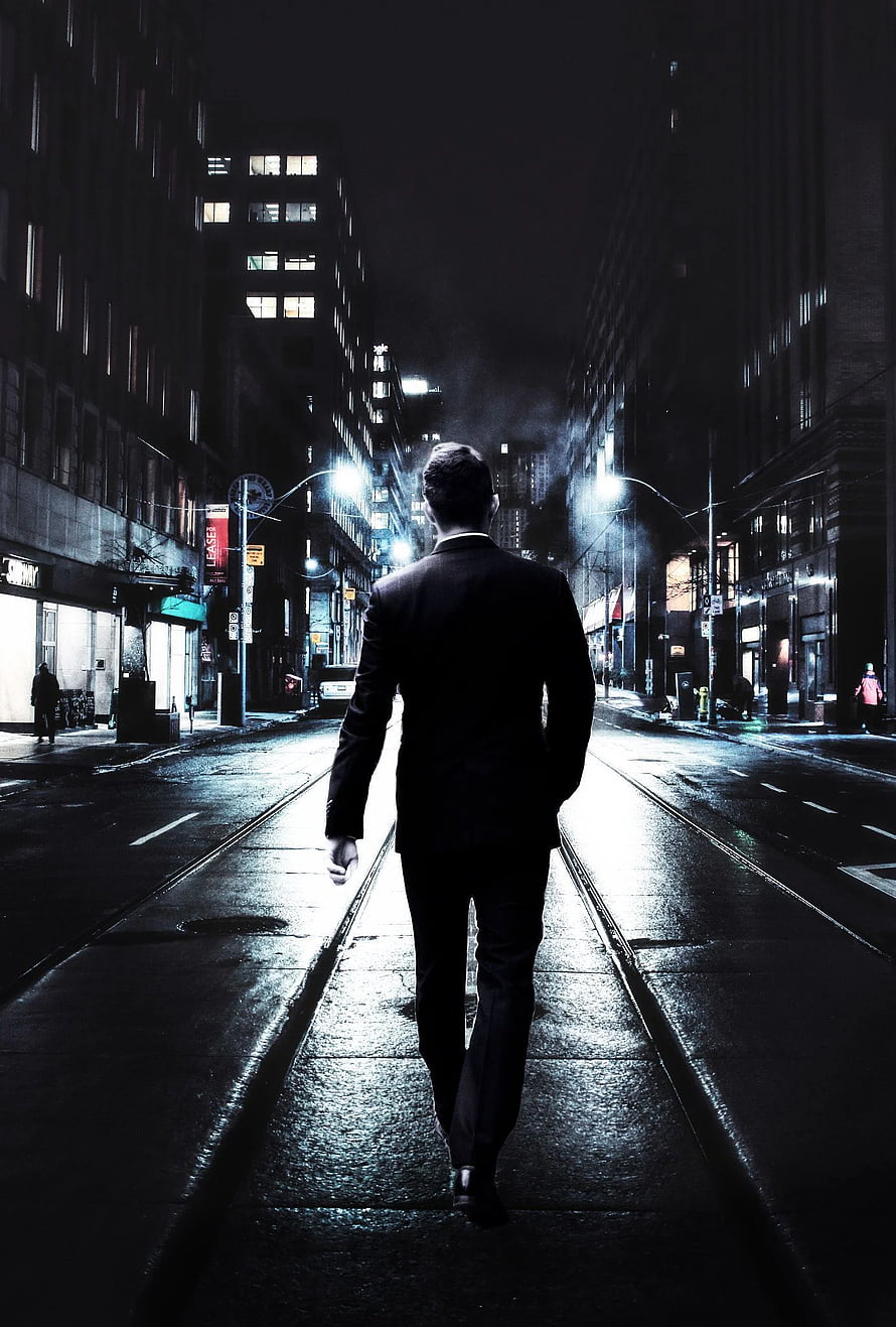 Silhouette of a man in a suit walking down a wet city street at night HD phone wallpaper