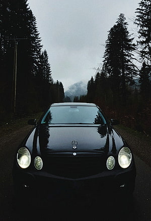 Black Mercedes-Benz W211 E-Class Front View on a Misty Forest Road HD phone wallpaper