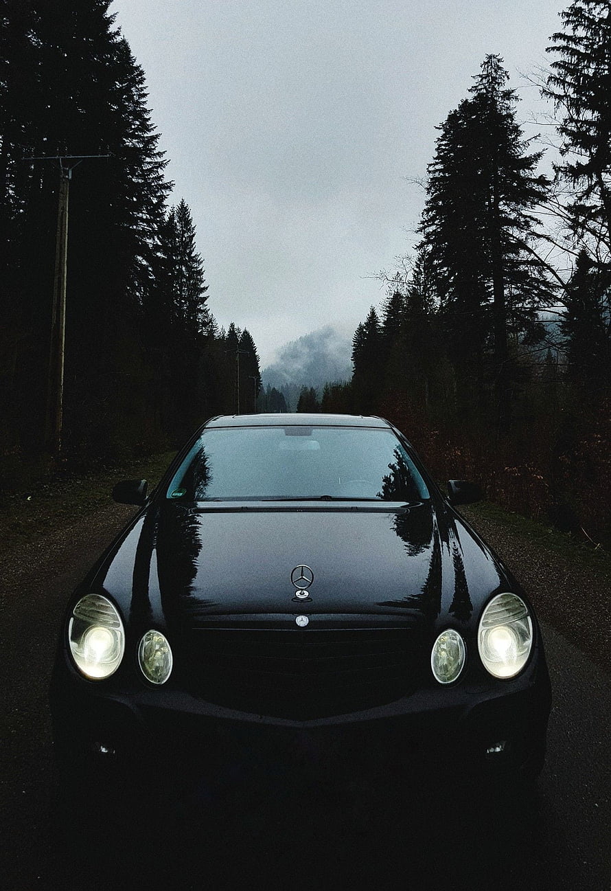 Black Mercedes-Benz W211 E-Class Front View on a Misty Forest Road HD phone wallpaper