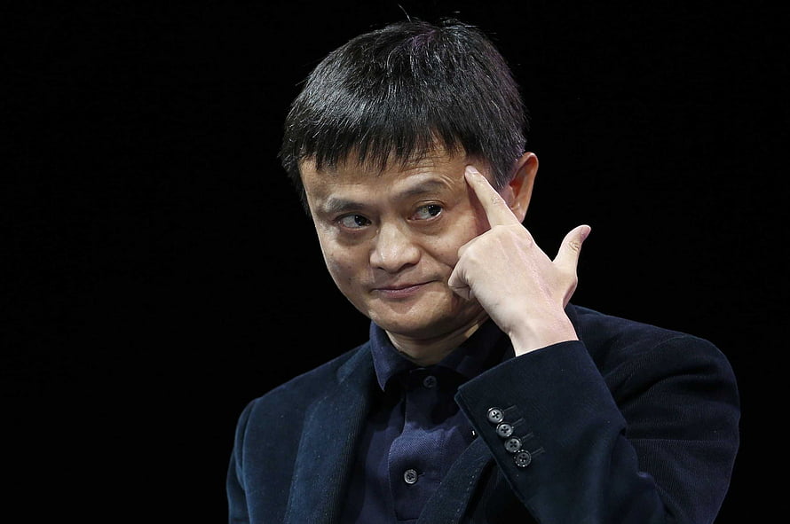 Jack Ma in a dark suit with finger to temple against a black background HD wallpaper