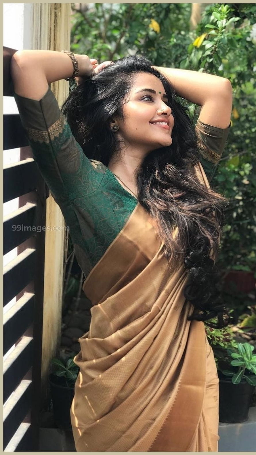 Anupama Parameswaran in a Green and Gold Silk Saree with Long Wavy Hair HD phone wallpaper