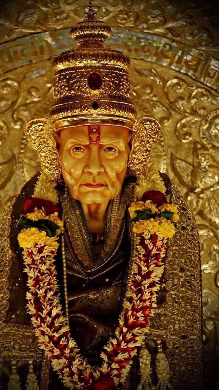 Ornate Golden Idol of Swami Samarth Adorned with Traditional Flower Garlands HD phone wallpaper