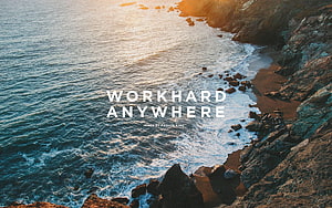 Aerial View of Rocky Coastal Cliffs and Ocean Waves at Golden Hour HD wallpaper