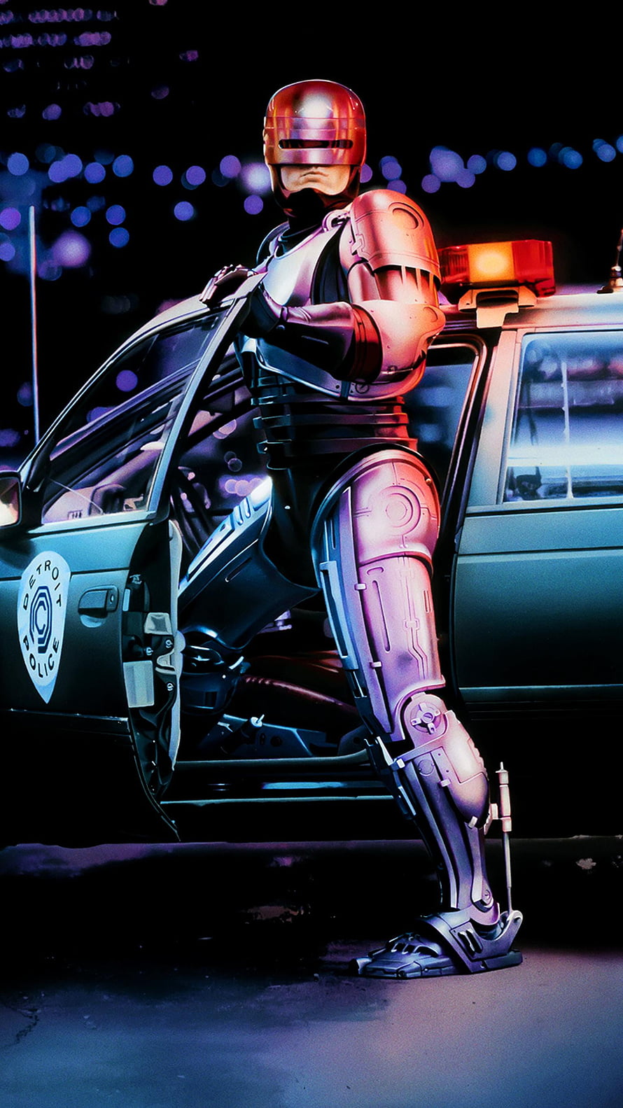 RoboCop Standing Beside a Detroit Police Car in a Neon-Lit Night Scene HD phone wallpaper