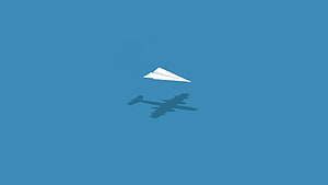 Minimalist Paper Airplane and Jet Shadow on Solid Blue Background HD wallpaper