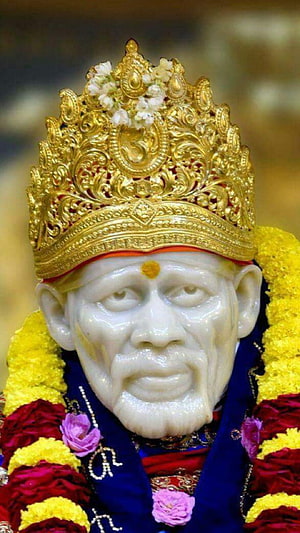 Sai Baba Marble Statue with Golden Crown and Floral Garlands HD phone wallpaper