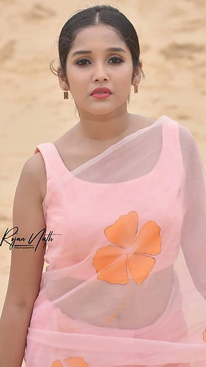 Anikha Surendran in a Pink Floral Saree with Orange Blossom Motif HD phone wallpaper