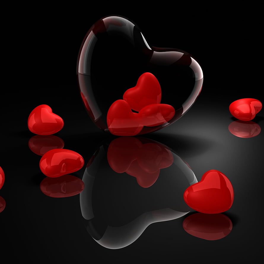 Glossy red hearts inside a transparent glass heart on a reflective black surface HD phone wallpaper