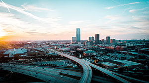 Oklahoma City Skyline at Golden Hour with Elevated Highway and Downtown Skyscrapers HD wallpaper