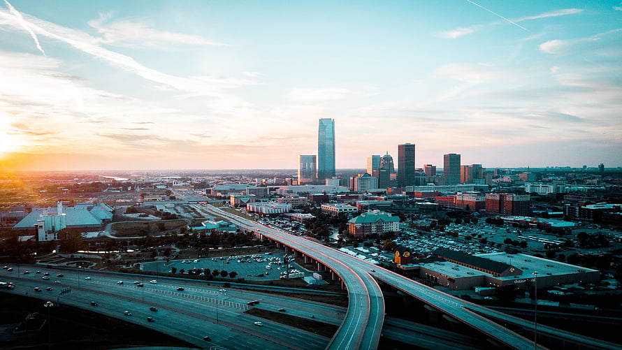 Oklahoma City Skyline at Golden Hour with Elevated Highway and Downtown Skyscrapers HD wallpaper