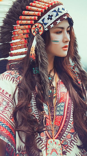 Portrait of a woman wearing a beaded Native American headdress and patterned bohemian top HD phone wallpaper