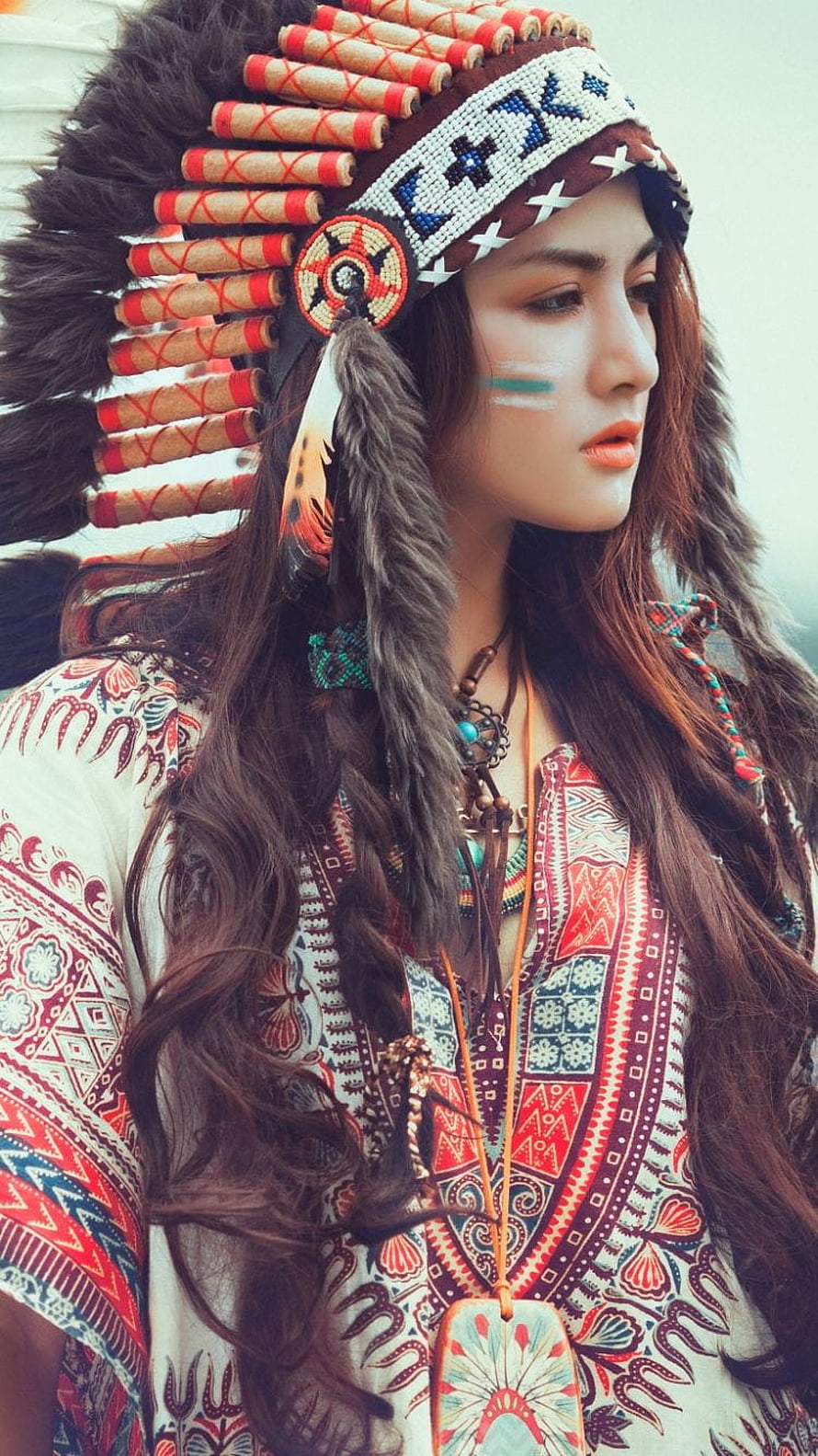 Portrait of a woman wearing a beaded Native American headdress and patterned bohemian top HD phone wallpaper