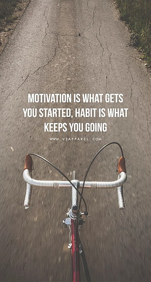First-person view of a road bike handlebar on a cracked asphalt path with an inspirational quote overlay HD phone wallpaper