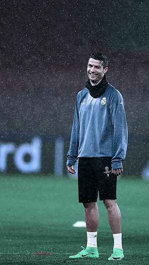 Cristiano Ronaldo in Real Madrid Training Kit on a Rainy Football Pitch HD phone wallpaper