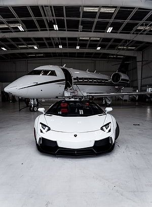 White Lamborghini Aventador Parked in Front of Private Jet Inside Hangar HD phone wallpaper