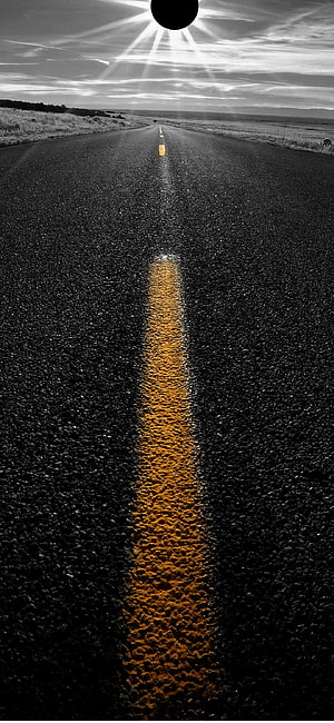 Black and White Highway with Golden Center Line and Sunburst Sky HD phone wallpaper