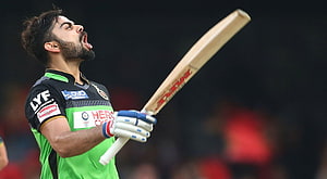 Virat Kohli celebrating with bat raised in Royal Challengers Bangalore green jersey HD wallpaper