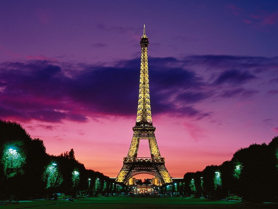 Eiffel Tower Illuminated Against a Vibrant Purple and Pink Sunset Sky in Paris HD wallpaper