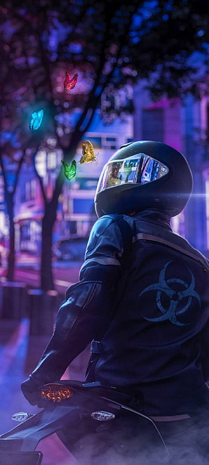 Biker in Black Leather Jacket with Biohazard Symbol Riding Motorcycle at Night with Neon Butterflies HD phone wallpaper