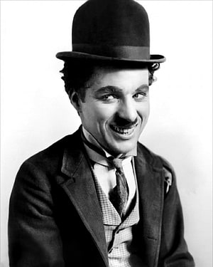 Classic Black and White Portrait of Charlie Chaplin in Iconic Bowler Hat and Suit HD phone wallpaper