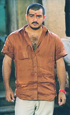 Ajith Kumar in a Rustic Brown Shirt with Traditional Red Mark and Bracelet HD phone wallpaper