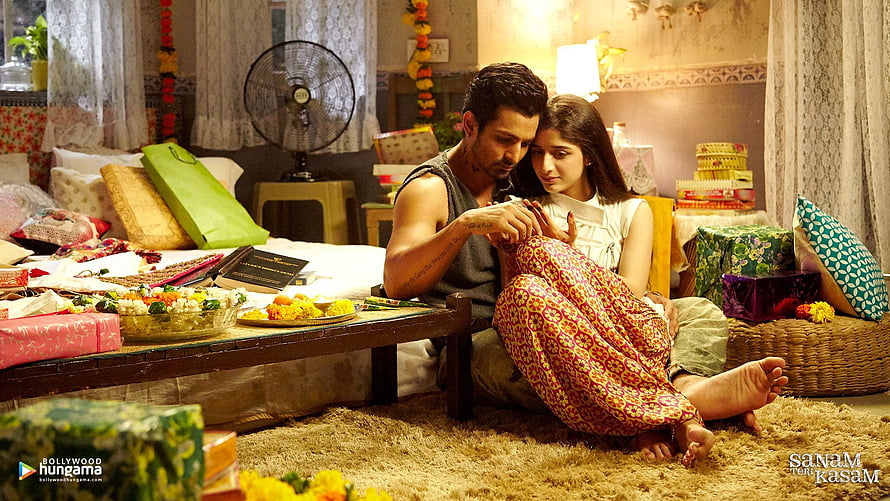 Sanam Teri Kasam Movie Still: Intimate Bedroom Scene with Couple and Festive Decorations HD wallpaper