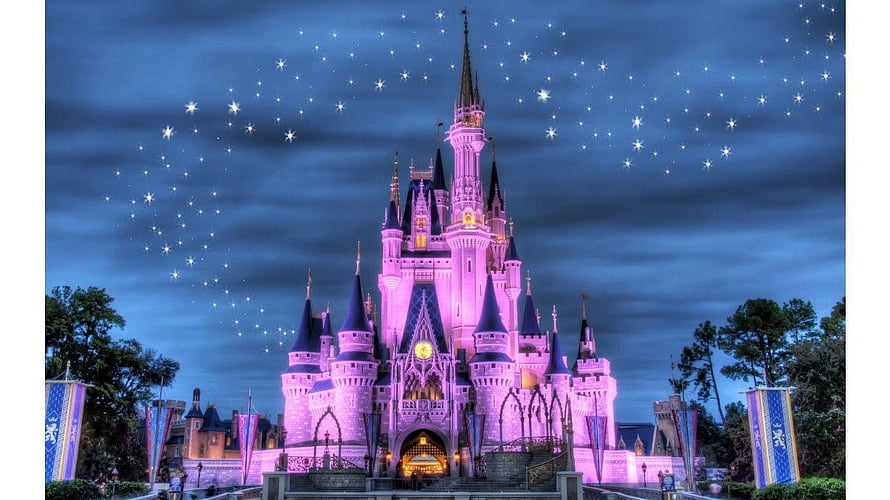 Cinderella Castle at Walt Disney World Illuminated in Pink Under a Starry Night Sky HD wallpaper