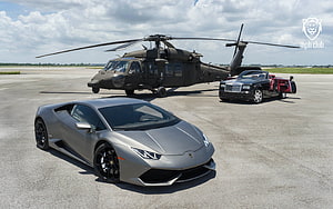 Silver Lamborghini Huracan, Black Rolls-Royce and Military Helicopter on Airfield Tarmac HD wallpaper