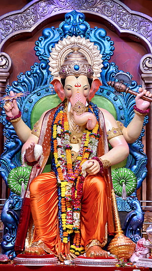 Lord Ganesha Murti Adorned With Marigold Garlands And Traditional Temple Jewelry HD phone wallpaper