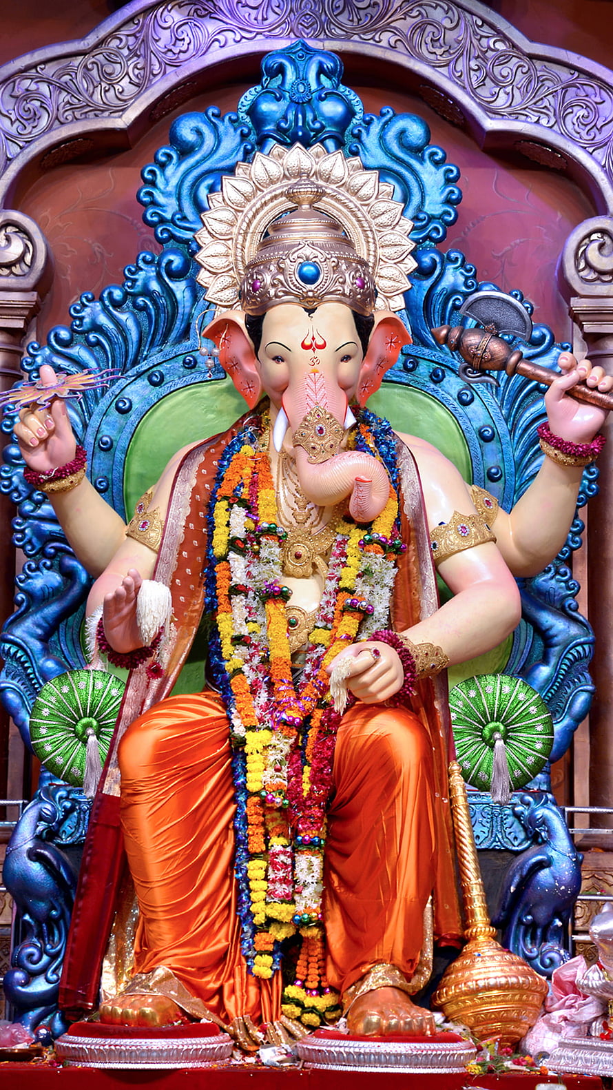 Lord Ganesha Murti Adorned With Marigold Garlands And Traditional Temple Jewelry HD phone wallpaper