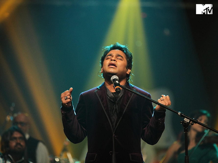 A R Rahman performing live on stage with dramatic concert lighting and a full band HD wallpaper