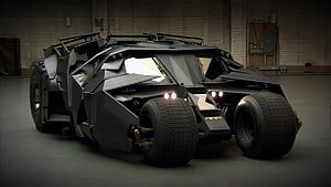 The Tumbler Batmobile from The Dark Knight in a dimly lit industrial garage HD wallpaper