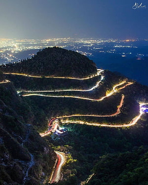 Mussoorie Night View: Illuminated Winding Mountain Road and City Lights HD phone wallpaper