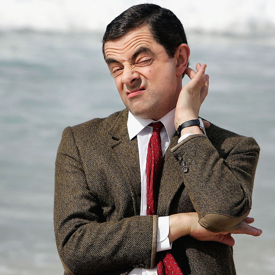 Rowan Atkinson as Mr Bean making a comical face in a tweed jacket and red tie HD phone wallpaper