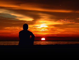 Silhouette of a Man Watching a Dramatic Orange Sunset Over the Ocean, Lonely mood sad alone sadness emotion people loneliness Solitude, Sad Alone Man HD wallpaper