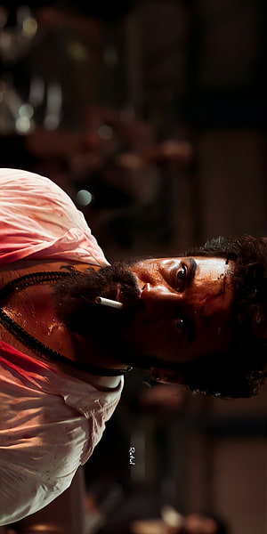 Suriya as Kaithi in a gritty close-up with cigarette and blood-stained shirt HD phone wallpaper