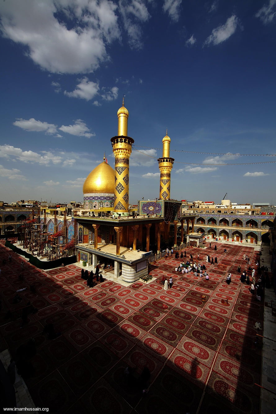 Karbala Shrine with Golden Domes and Minarets Under a Blue Sky HD phone wallpaper