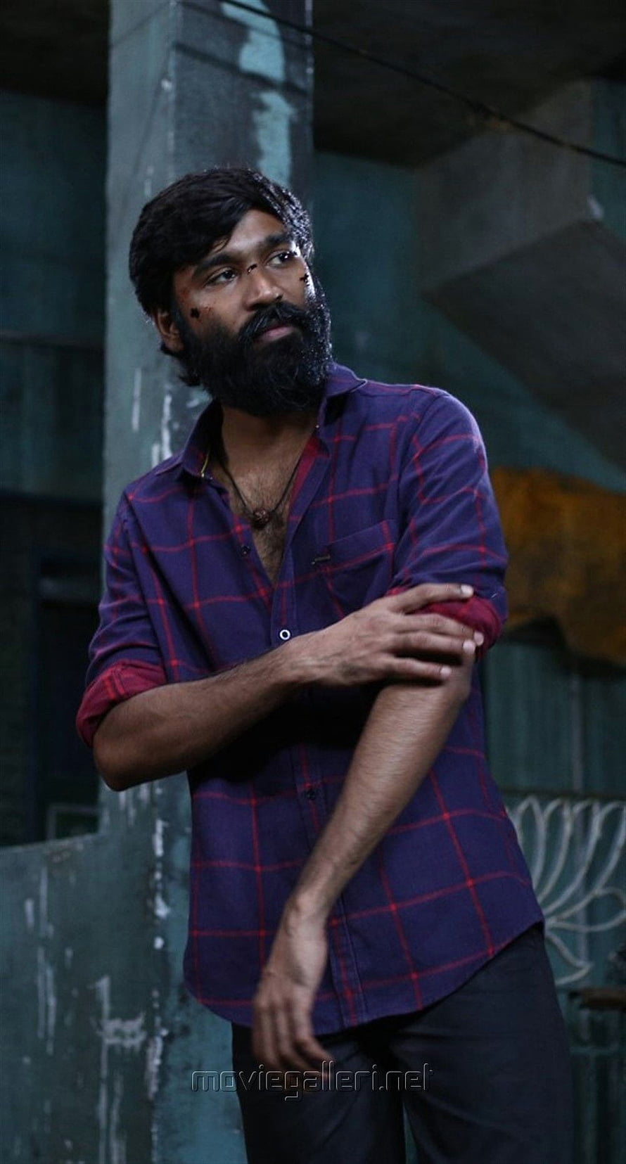 Dhanush in Vada Chennai wearing a purple plaid shirt with a serious expression HD phone wallpaper