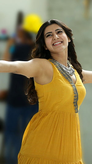 Samantha Akkineni in a vibrant yellow dress with silver jewelry and a joyful expression HD phone wallpaper