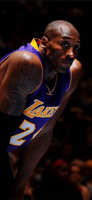 Kobe Bryant in Lakers Jersey Leaning Forward During Intense Game Action HD phone wallpaper