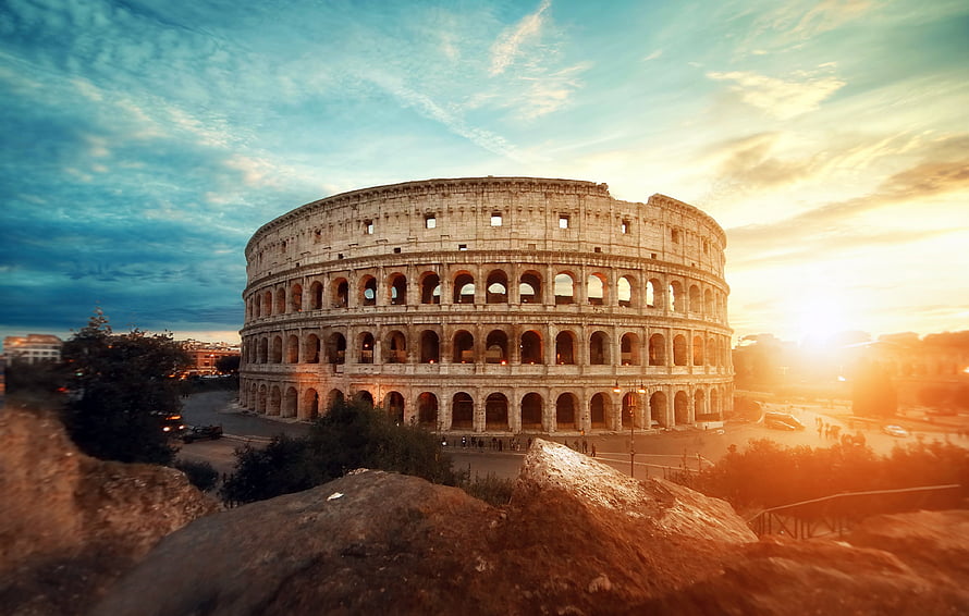 Colosseum in Rome at Golden Hour with Dramatic Sky and Ancient Roman Architecture HD wallpaper