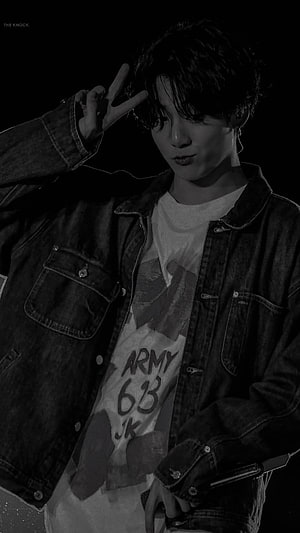 Jungkook from BTS in a black and white portrait wearing a denim jacket and peace sign HD phone wallpaper