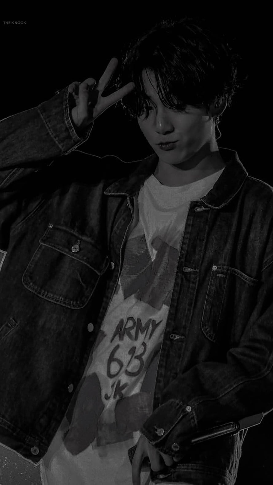 Jungkook from BTS in a black and white portrait wearing a denim jacket and peace sign HD phone wallpaper