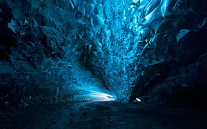 Glowing Blue Ice Cave Interior with Textured Walls and Natural Light HD wallpaper