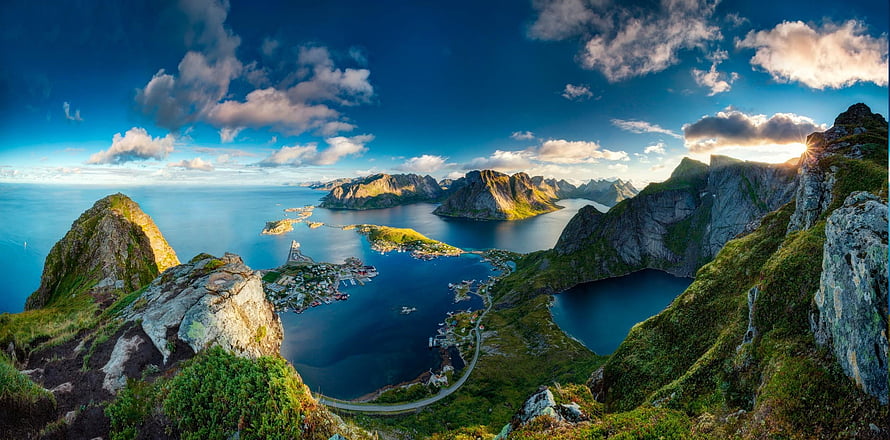 Aerial View of Dramatic Norwegian Fjord with Steep Green Cliffs and Coastal Village HD wallpaper
